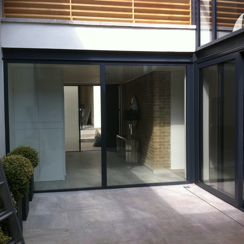 Floor-to-ceiling sliding doors opening to courtyard in Chesham