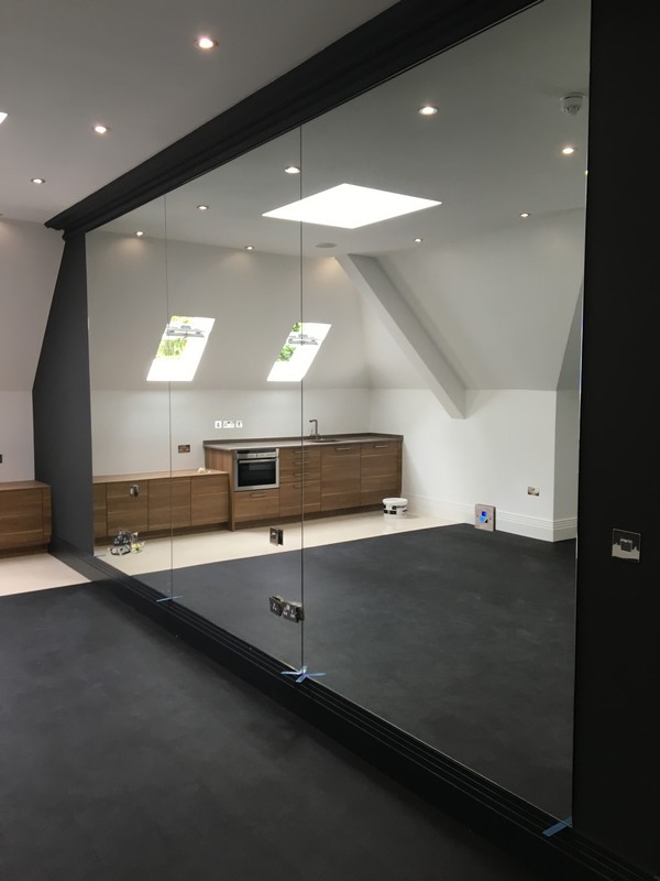 Frameless glass partition in loft conversion by Chesham glaziers