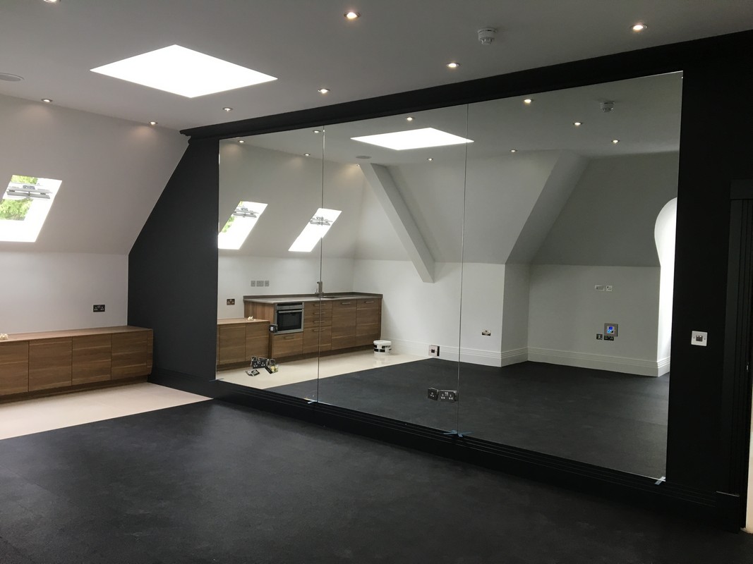 Frameless glass wall dividing loft conversion in Chesham